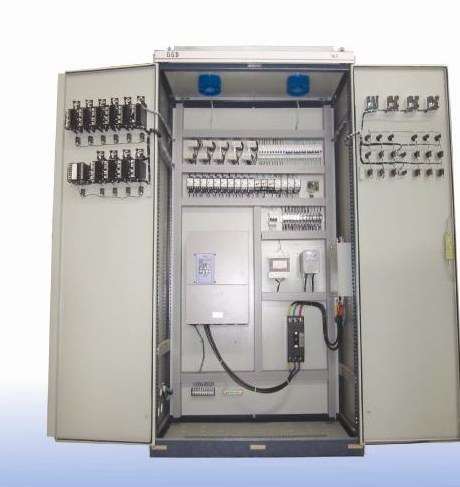 Interior of an extruder control cabinet showing relays, contactors and frequency drives